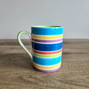 Whittard Designed in England Handpainted  mug with multicolored striped pattern.